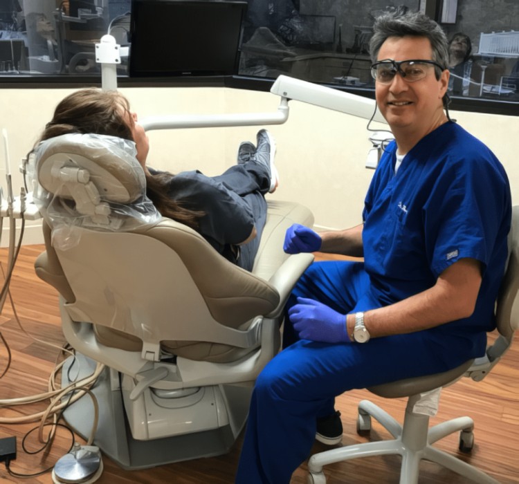 Dr. Robert Martini in his dental office with a patient
